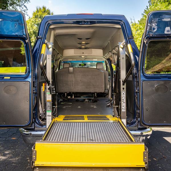 Wheelchair van with its lift lowered, ready for boarding